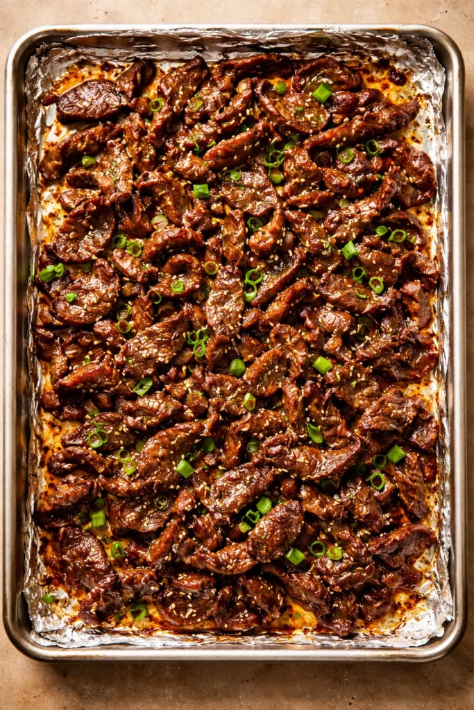 10 Sheet Pan Dinners With Almost No Cleanup 10 Beef bulgogi slices on a sheet pan with caramelized edges.
