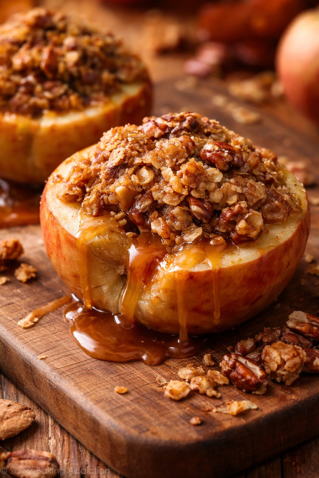 Halved baked apple with oat-pecan crisp and caramel inside
