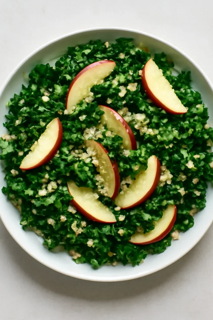 Salad arranged on a plate highlighting kale, quinoa, and apples