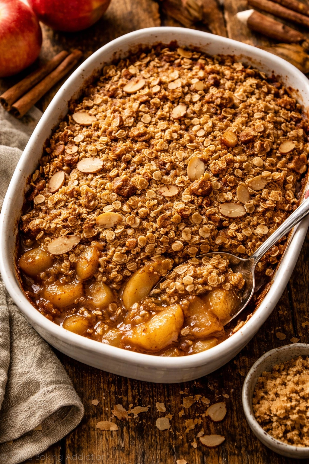 Close-up of spiced apple crisp with oat and almond topping in a baking dish