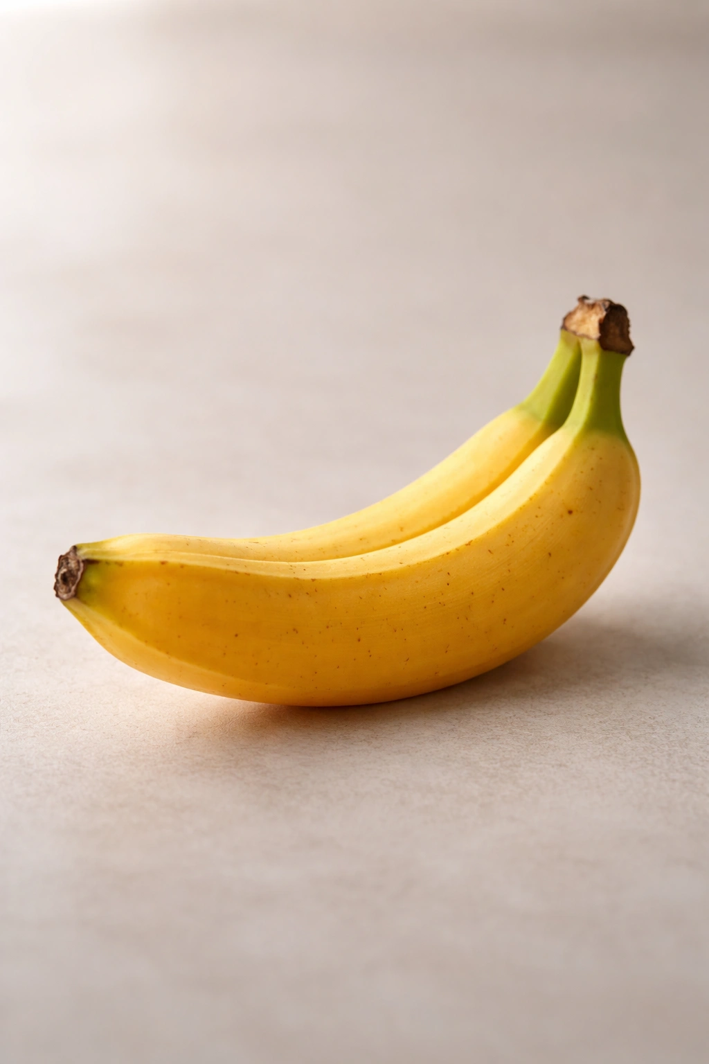 Close-up of a single ripe banana on a plain background