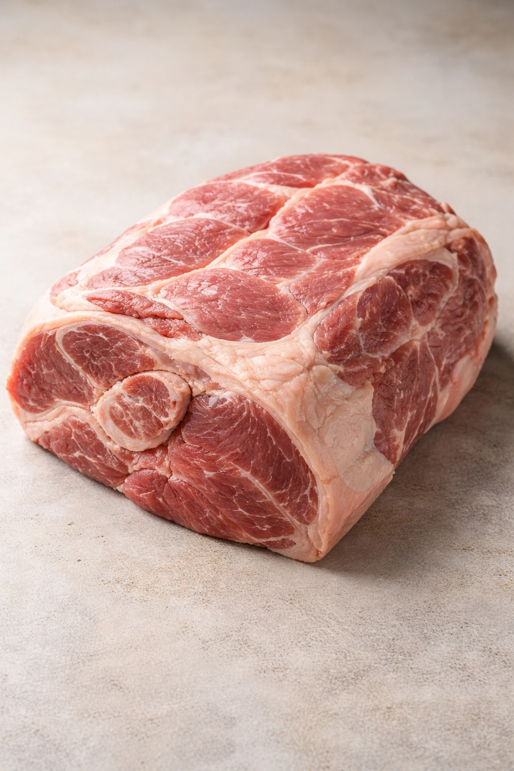 Bone-in pork shoulder roast showing marbling