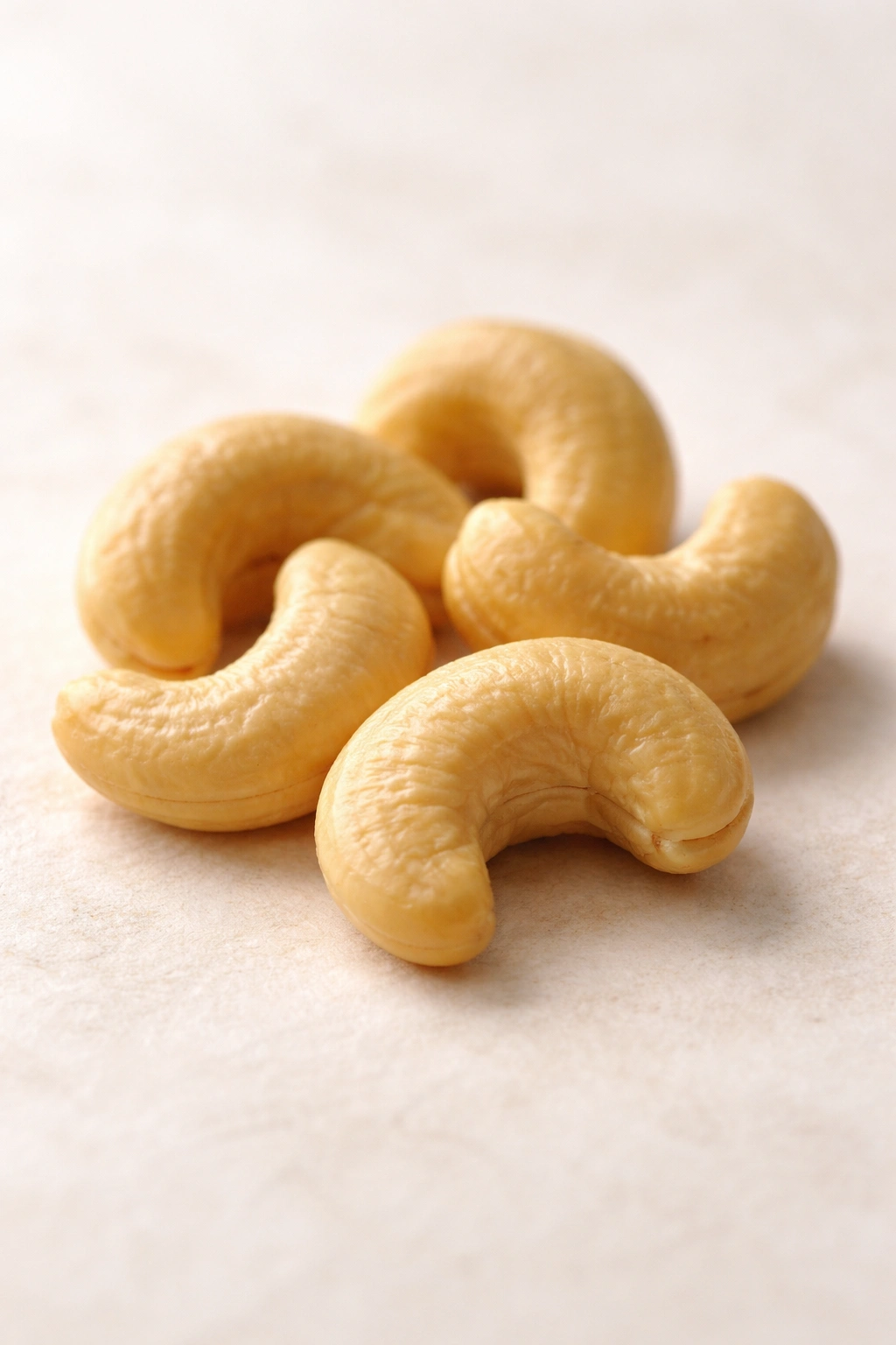 Cashews arranged on light background suggesting folate-rich prenatal nutrition