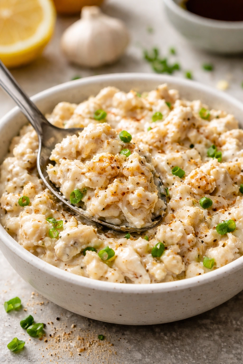 Creamy crab filling with seasoning flecks in a shallow dish