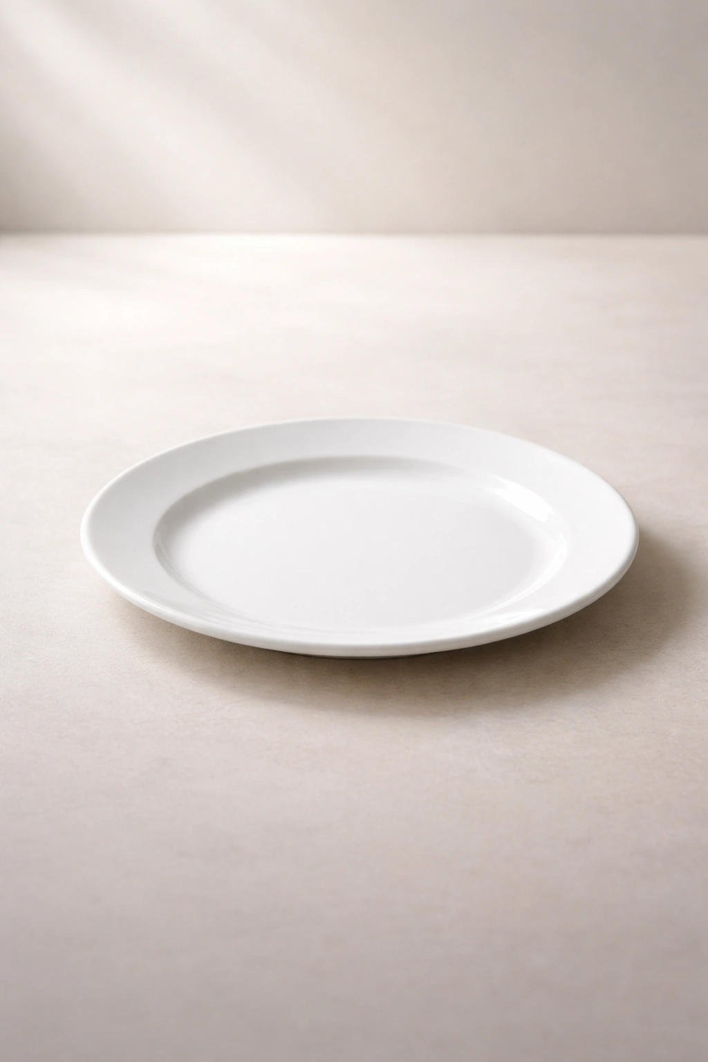 Empty white plate on neutral surface suggesting final takeaway