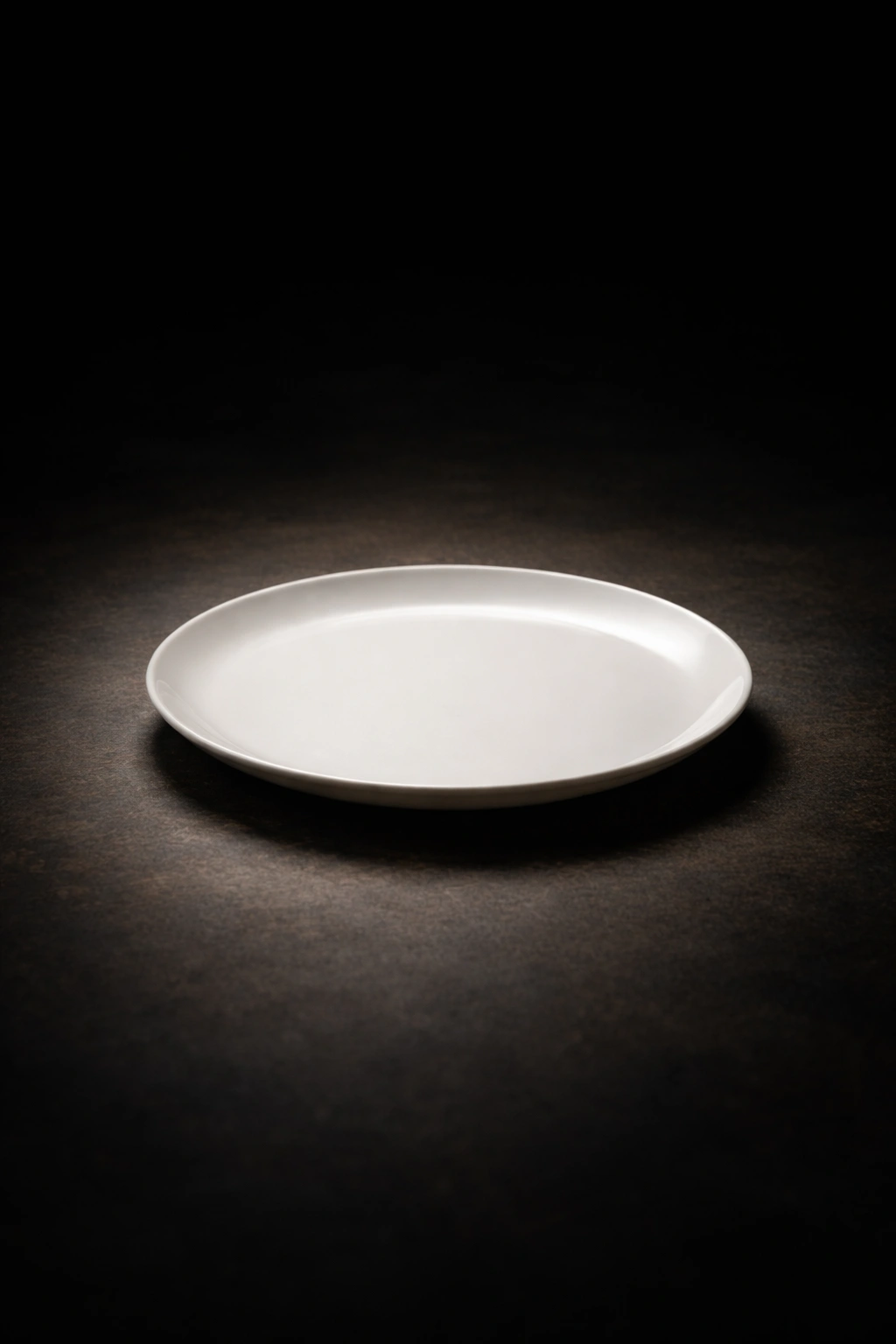 Minimalist still life of an empty plate on a dark background
