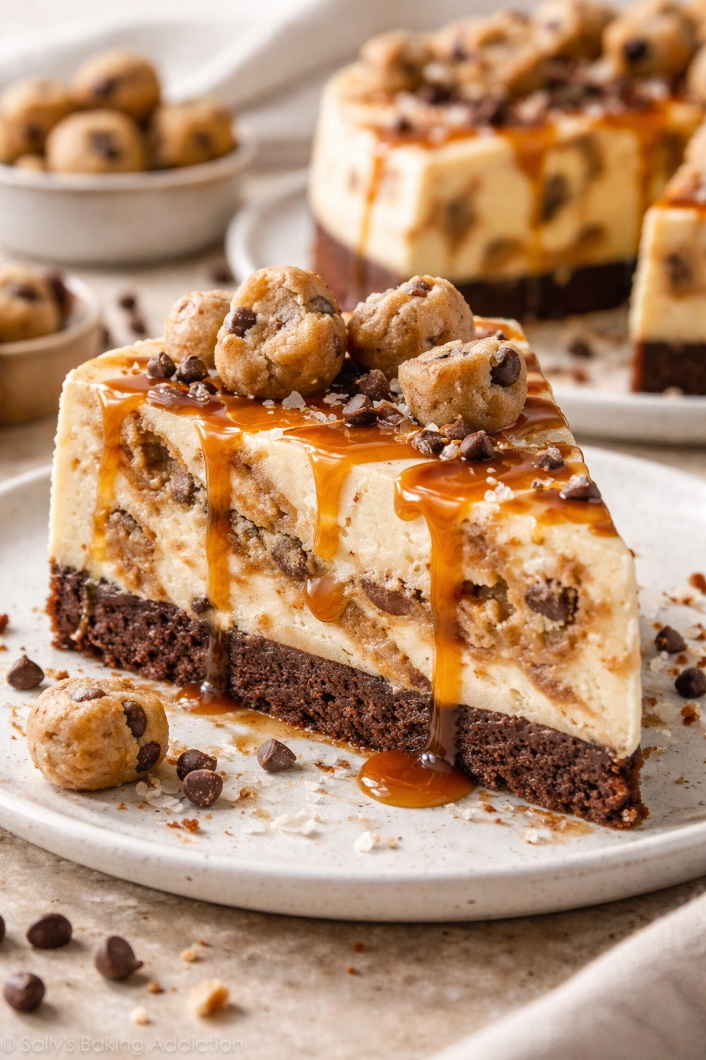 Cheesecake with caramel swirl and cookie dough chunks visible on top.