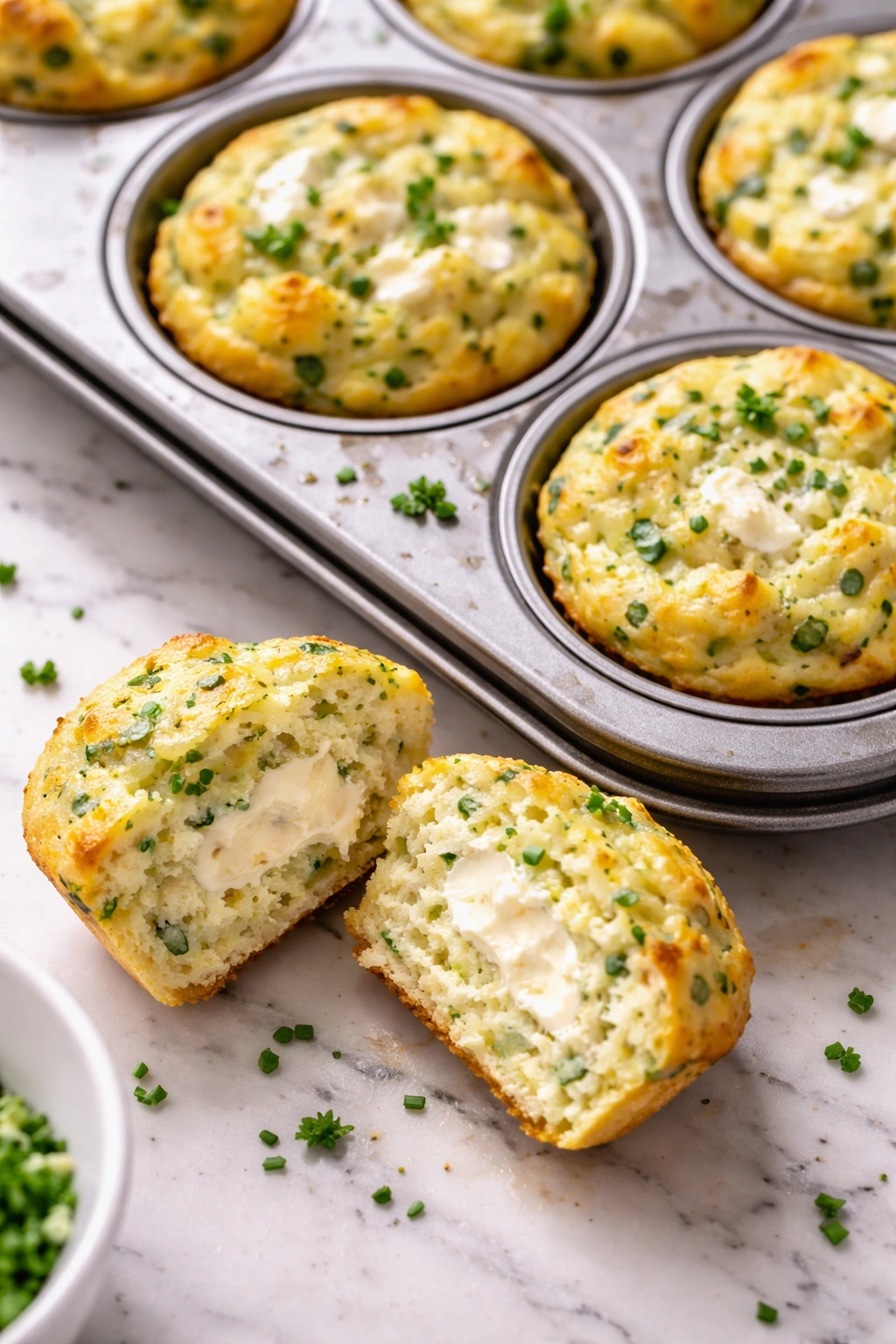 Cross-section of herb egg muffin showing creamy cream cheese filling