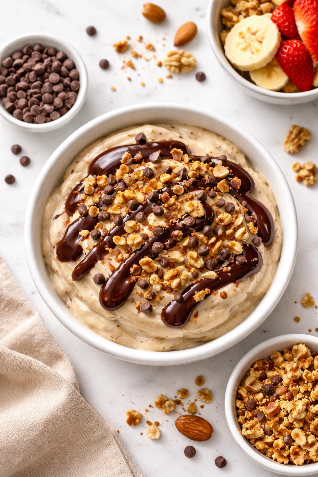 Nice cream bowl topped with chocolate drizzle and nuts