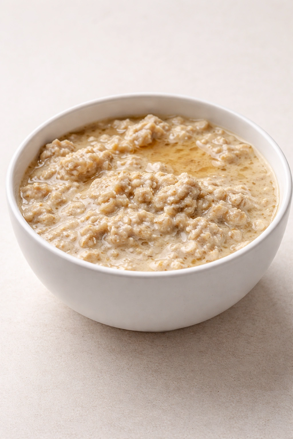 Overnight oats with liquid separation and uneven texture in a bowl