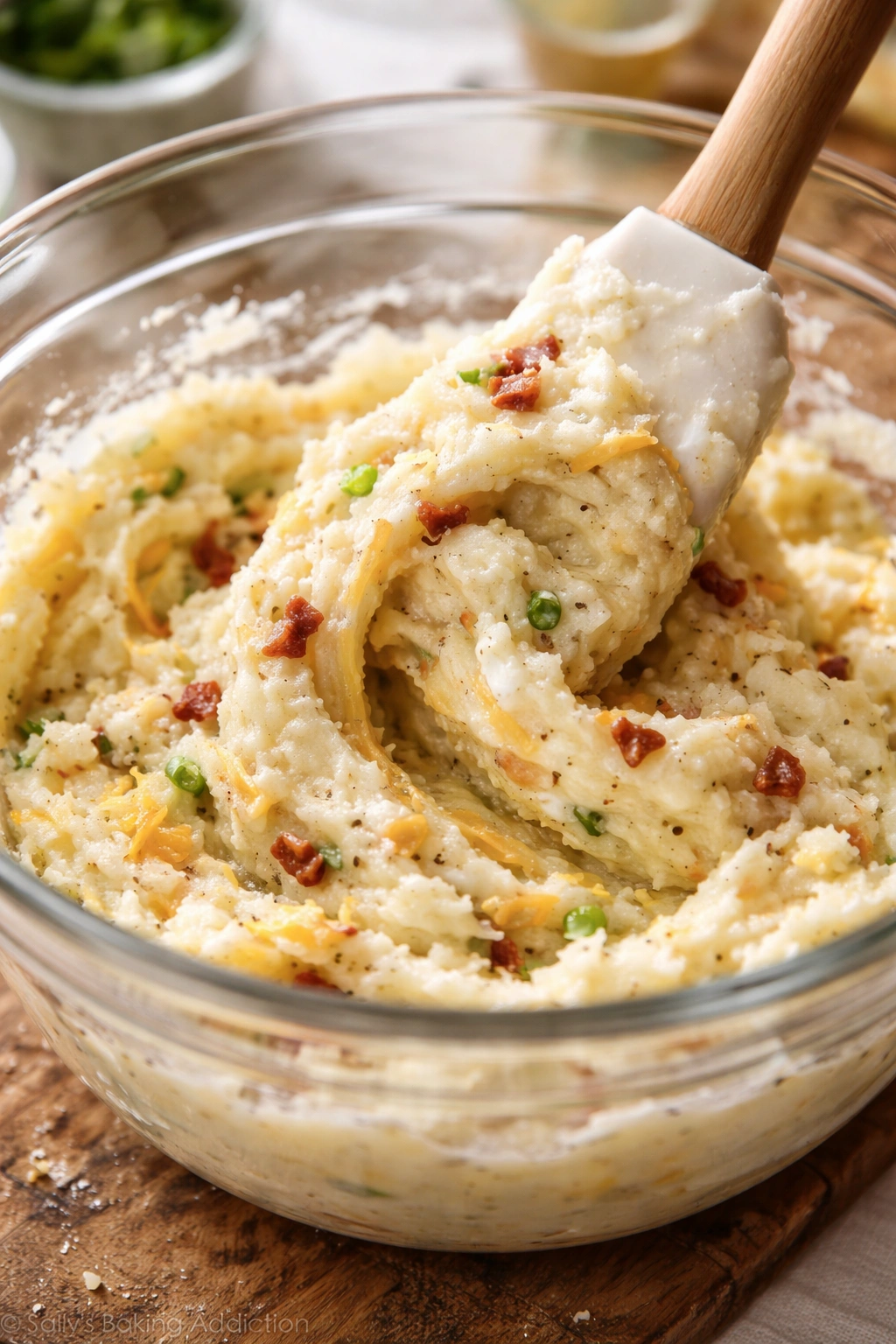 Fluffy mashed potato filling being gently folded in a bowl