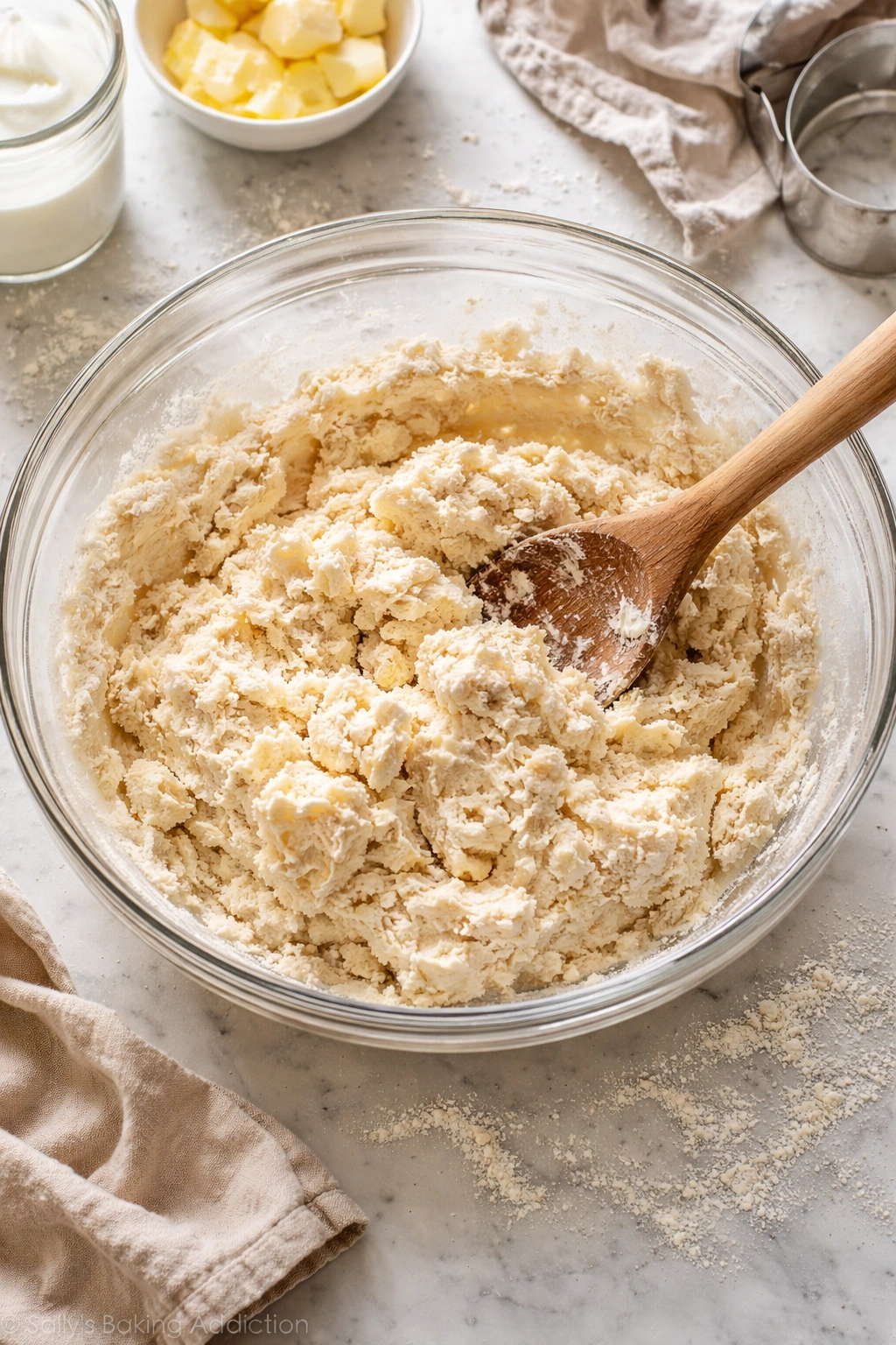 Shaggy dough with butter streaks in a mixing bowl