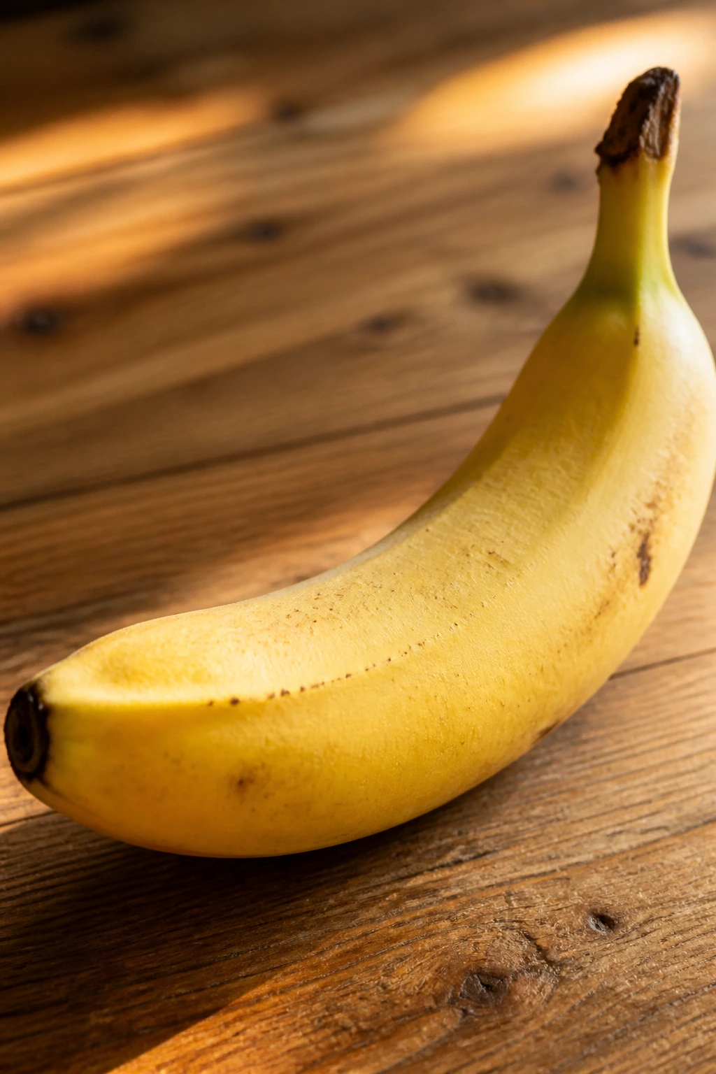 10 Surprising Benefits Of Bananas Sexually (Better In Bed) 2 Close-up of a ripe banana on a sunny kitchen counter