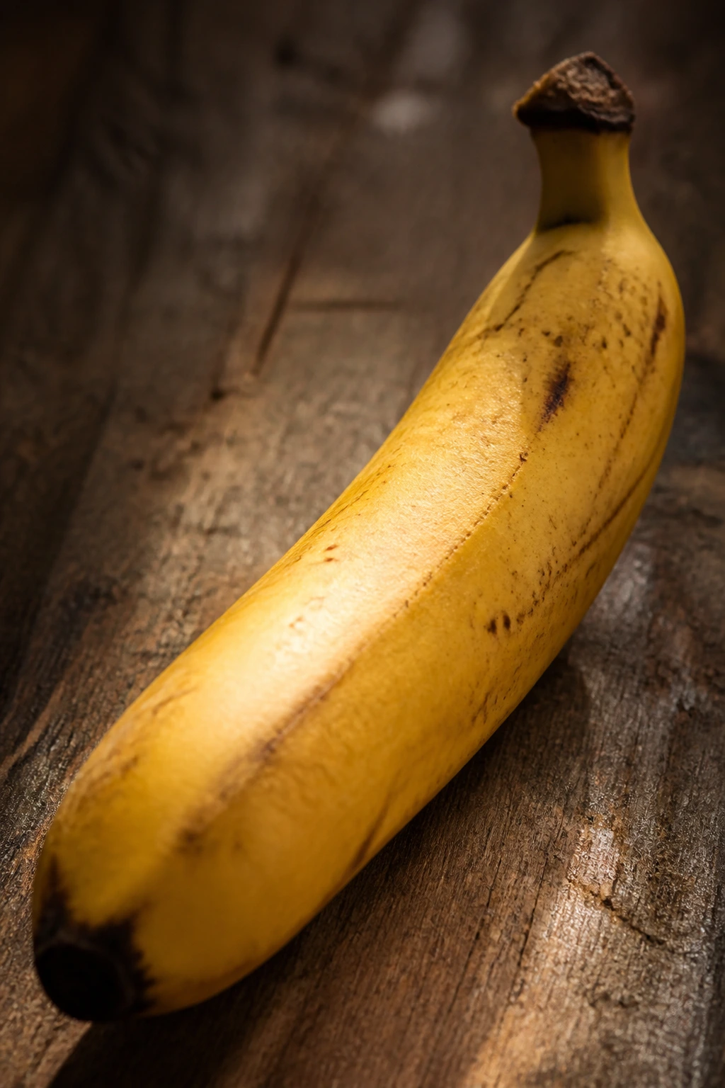 Ripe banana filling the frame on a wooden surface