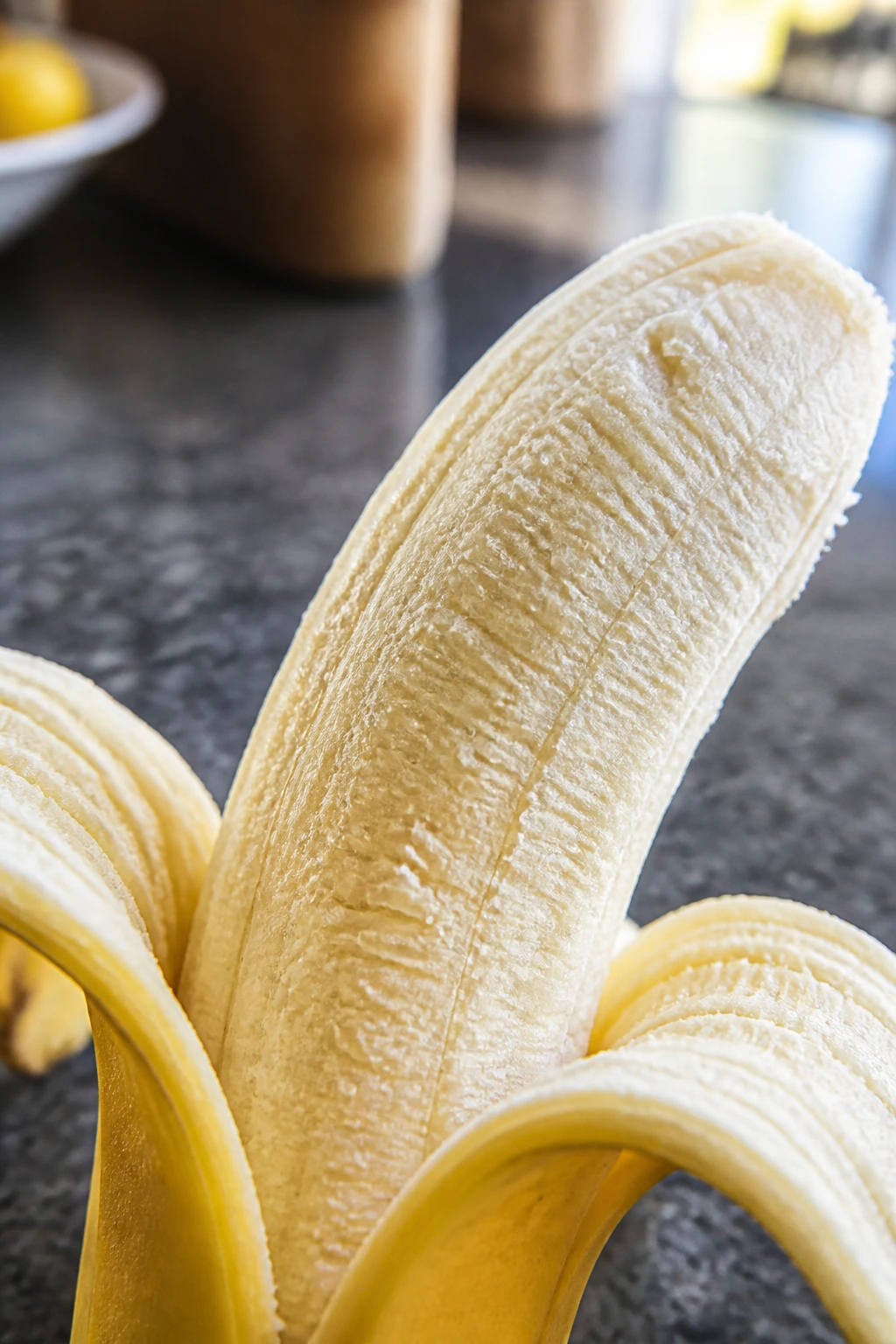 Botanical Insights: The Parts Of A Banana Plant 9 Close-up of peeled banana showing inner pulp and curling skin.