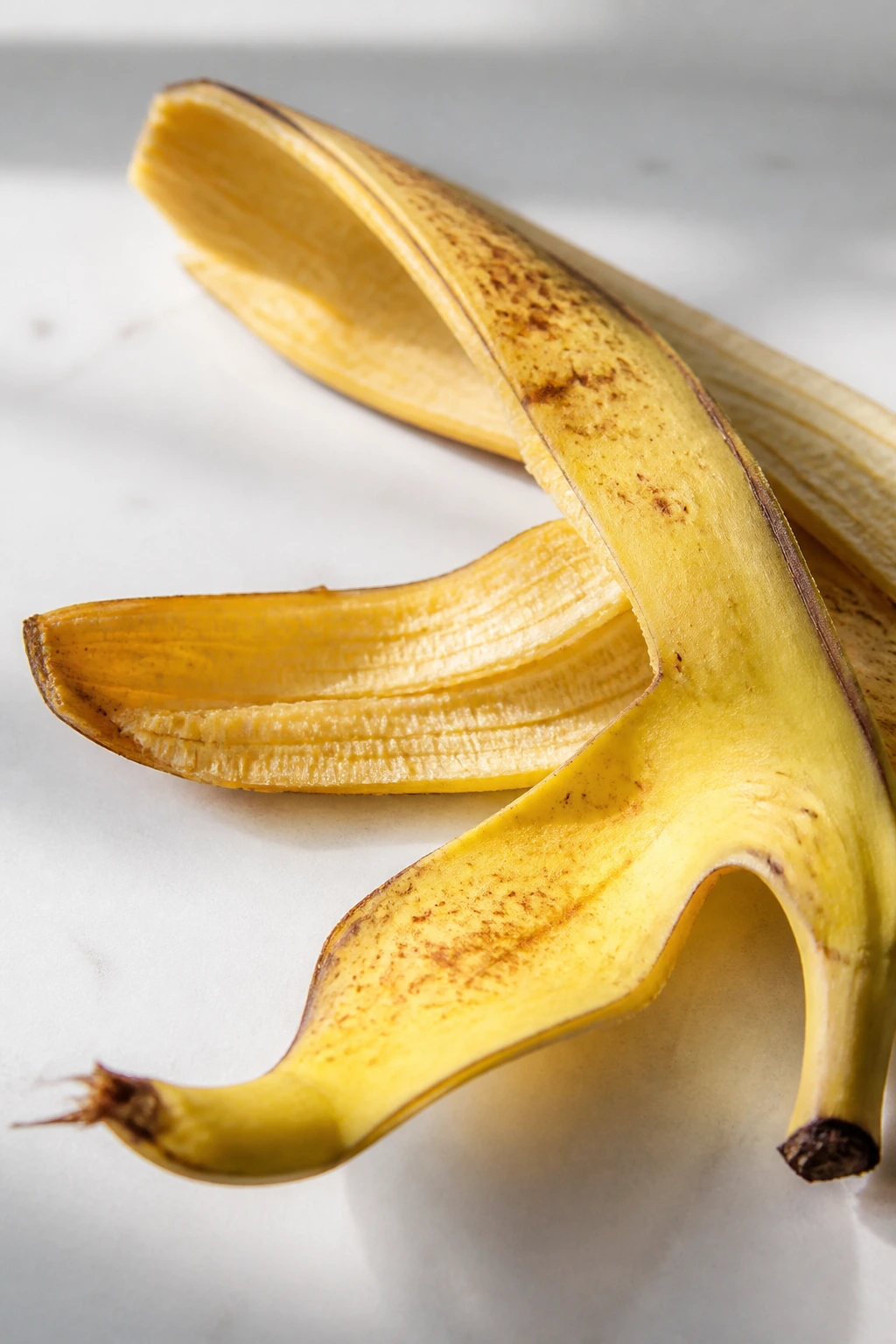 Close-up of a banana peel on a white countertop