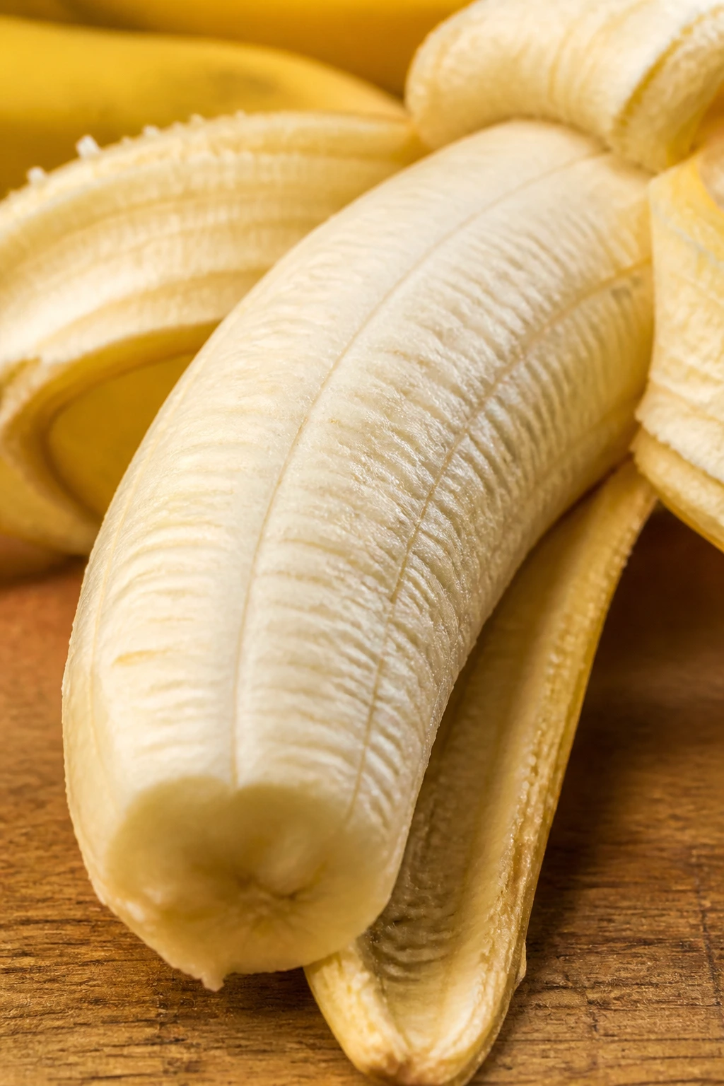 Macro close-up of a peeled banana showing creamy interior.