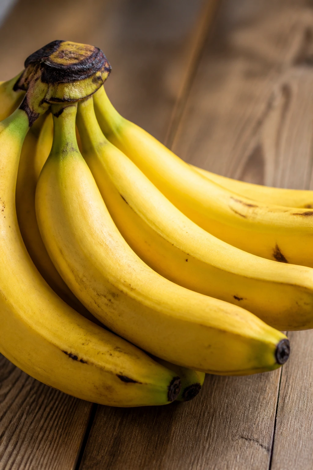 10 Benefits Of Banana To Women Sexually To Be Better In Bed 8 Close-up of banana bunch on wooden surface