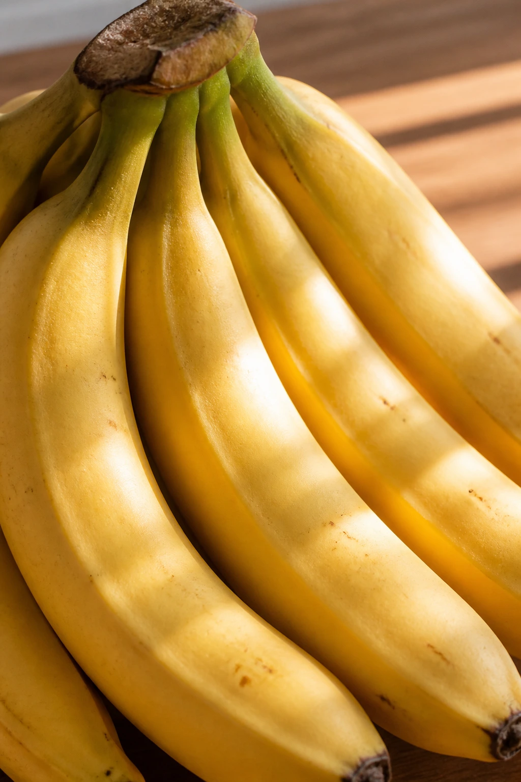 Is Banana and Peanut Butter Healthy? 1 Close-up of ripe bananas filling the frame on a wooden kitchen counter