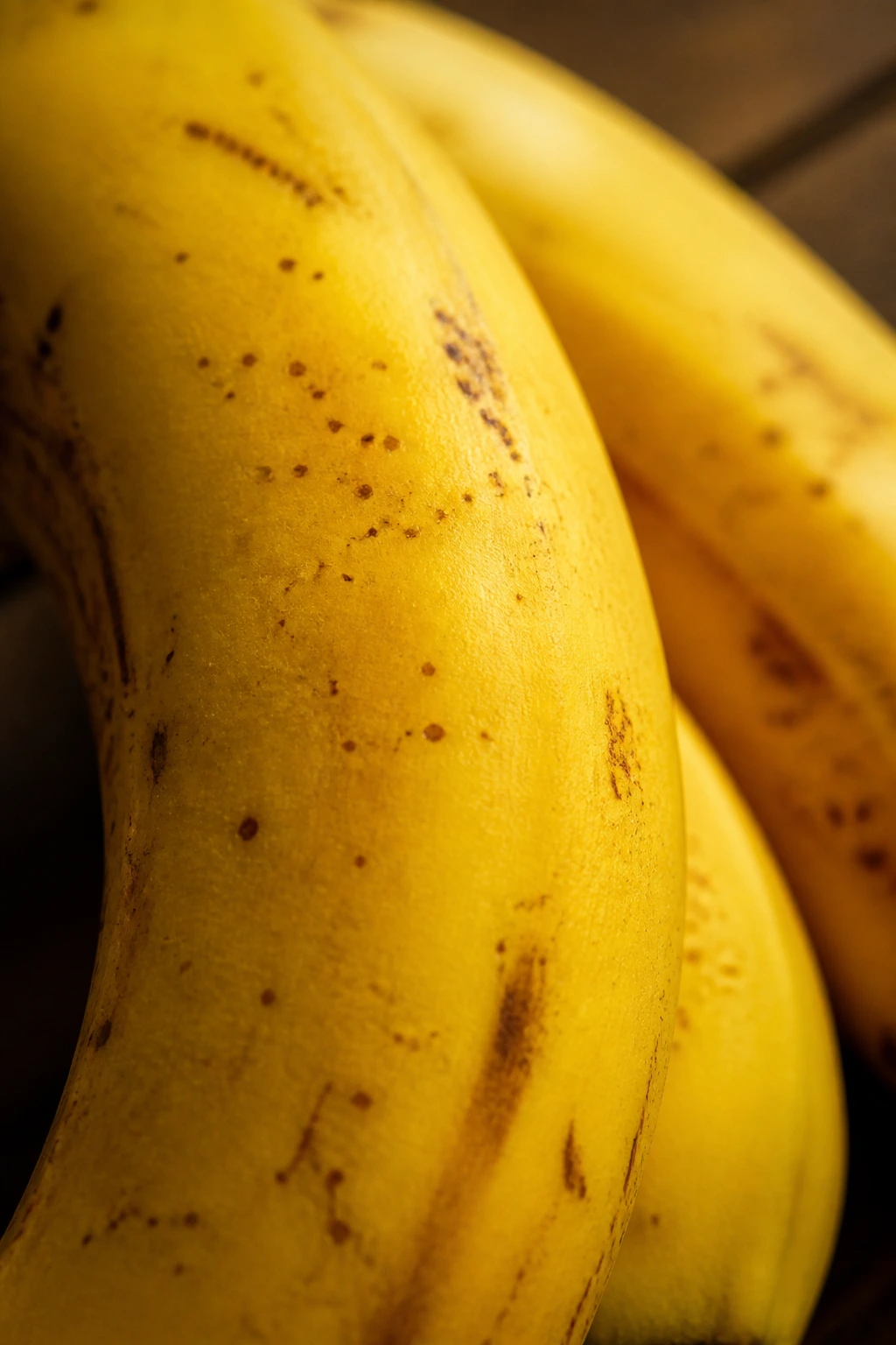 Macro close-up of banana skin texture on a wooden surface