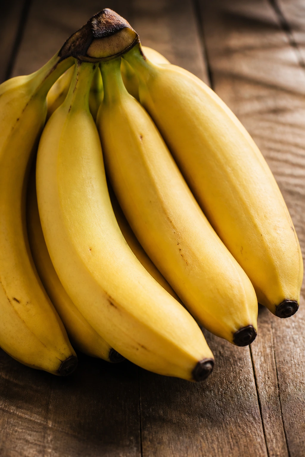 Close-up of ripe bananas filling the frame in a warm kitchen setting