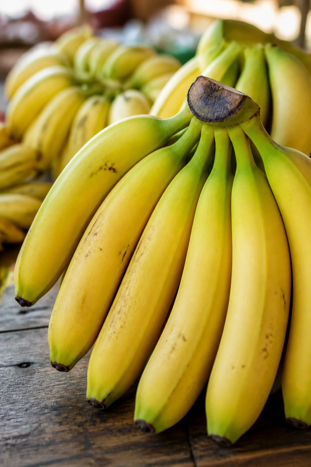How to Make Banana Chips Commercially: A Complete Guide 1 Close-up of bananas with green-tinged and yellow skins ready for selection in a market.