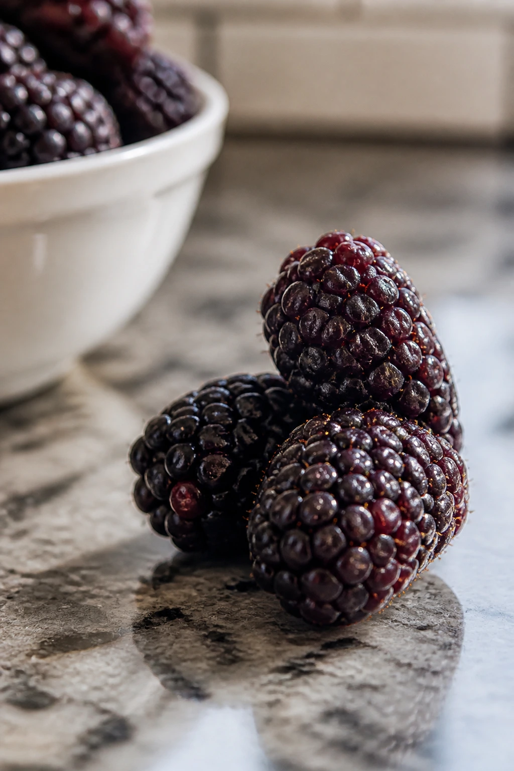Close-up of boysenberries on a kitchen counter.