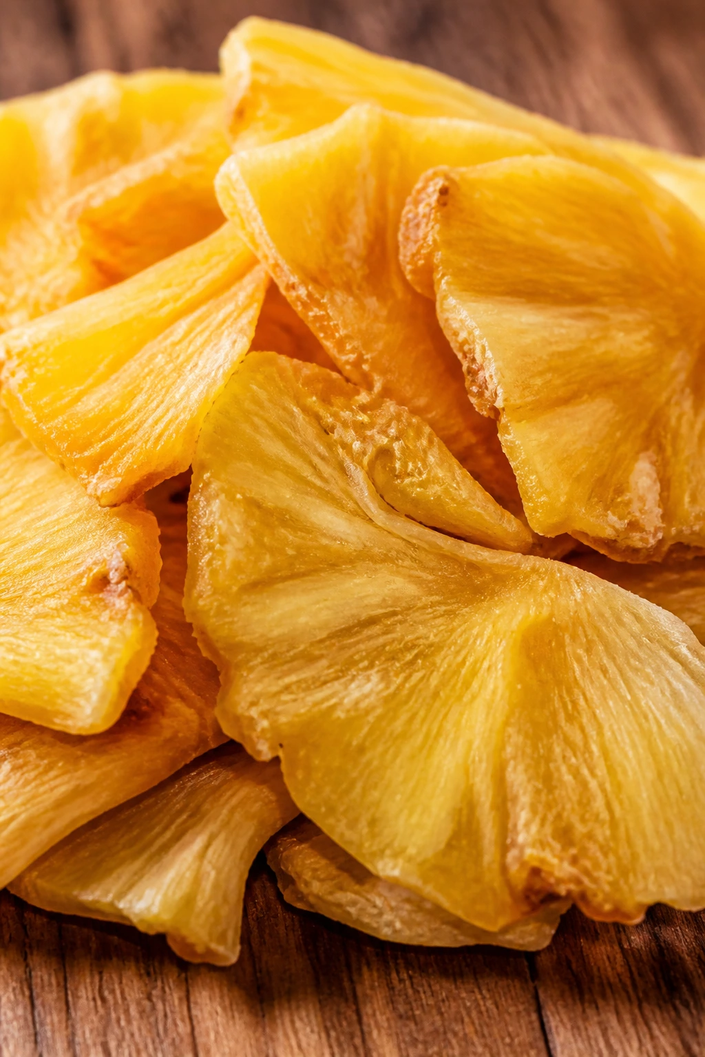 Pile of dried pineapple pieces showing texture and color.