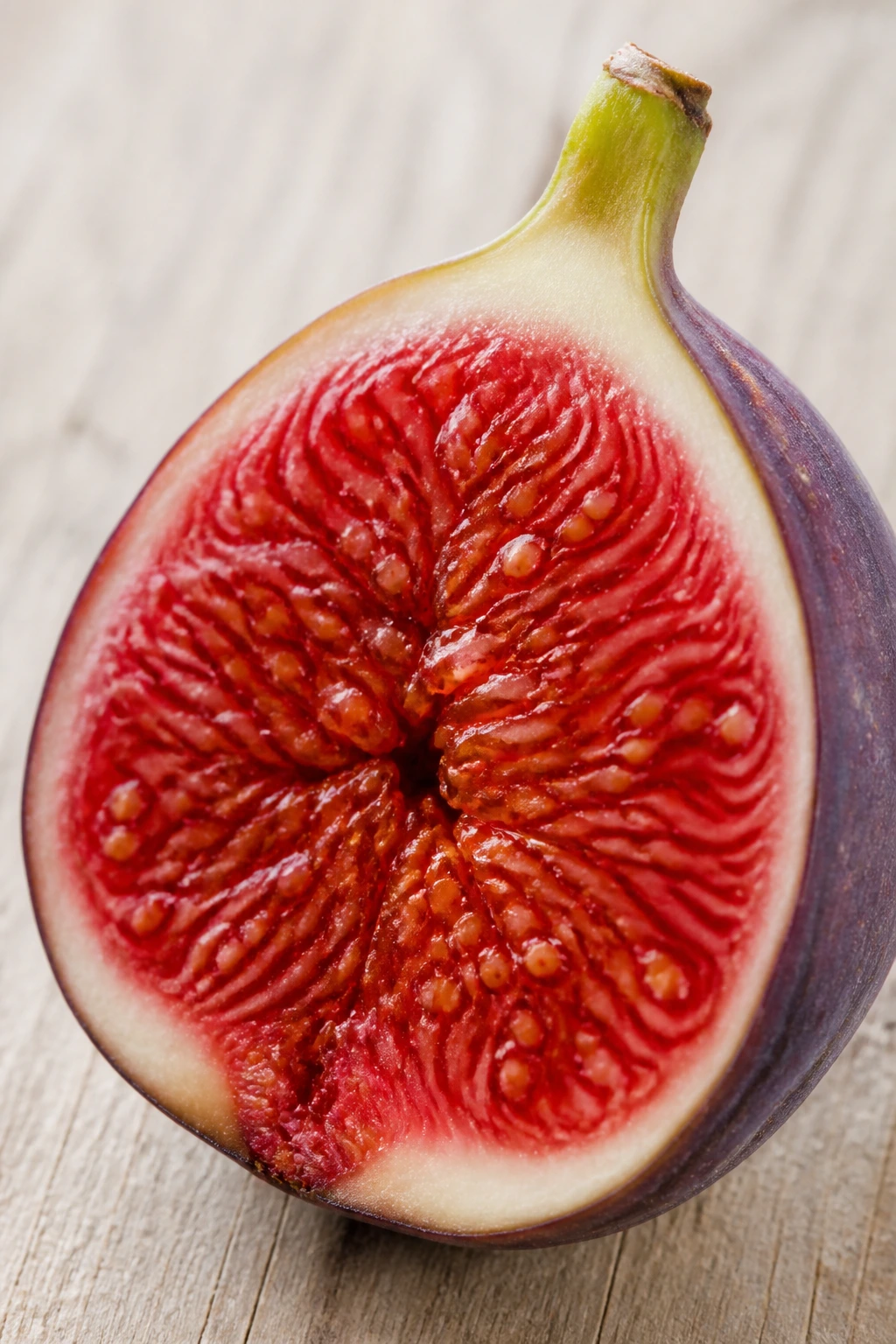 10 Astounding Health Benefits Of Fig Fruit During Pregnancy 5 Fig with crimson interior on pale wood
