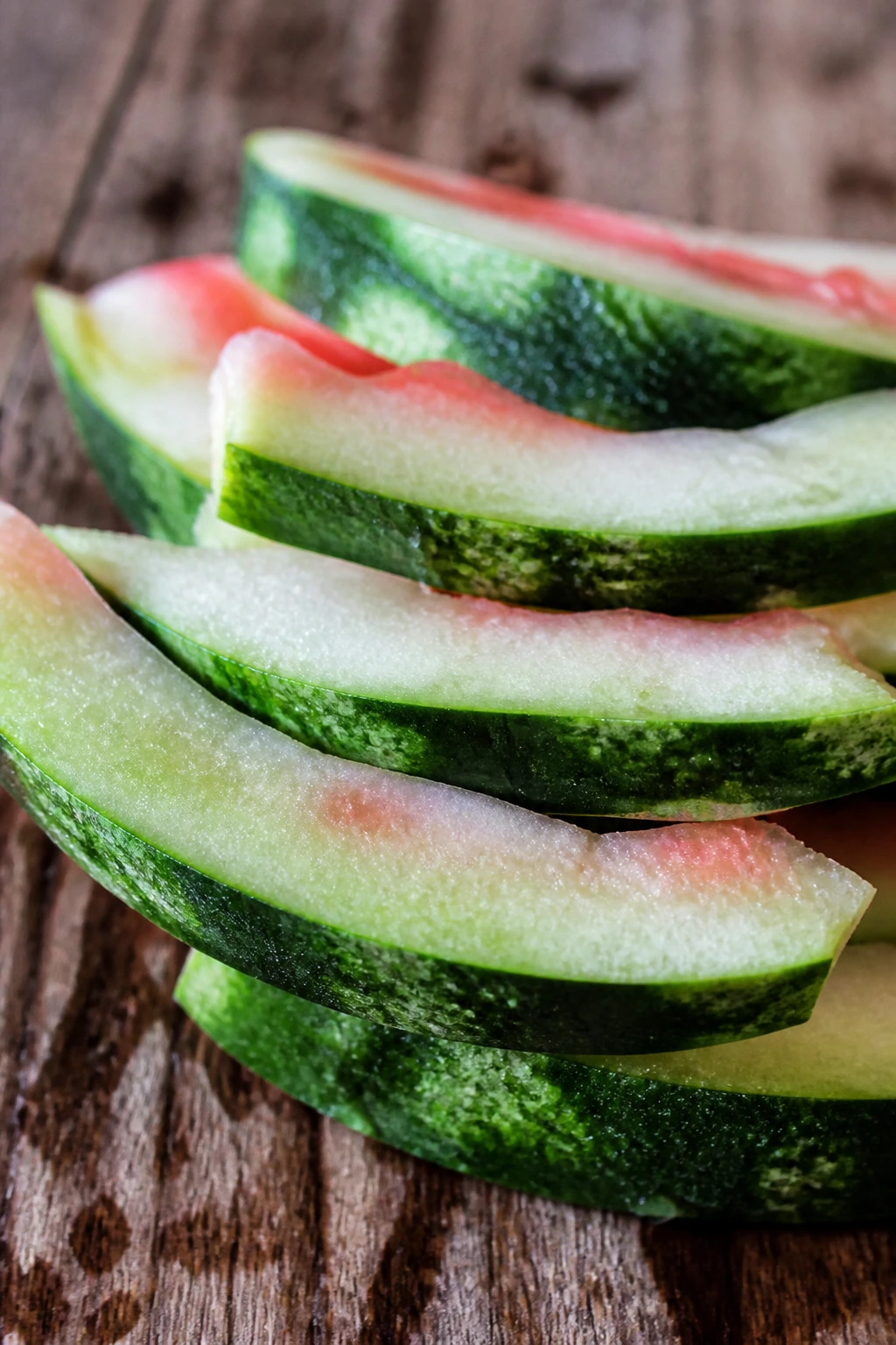Close-up of watermelon rind scraps on wood surface