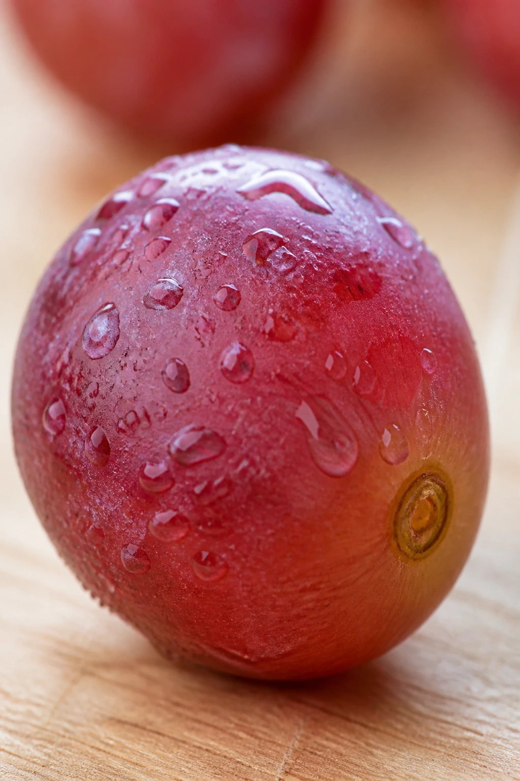 Close-up grape with dew on wooden counter in bright kitchen