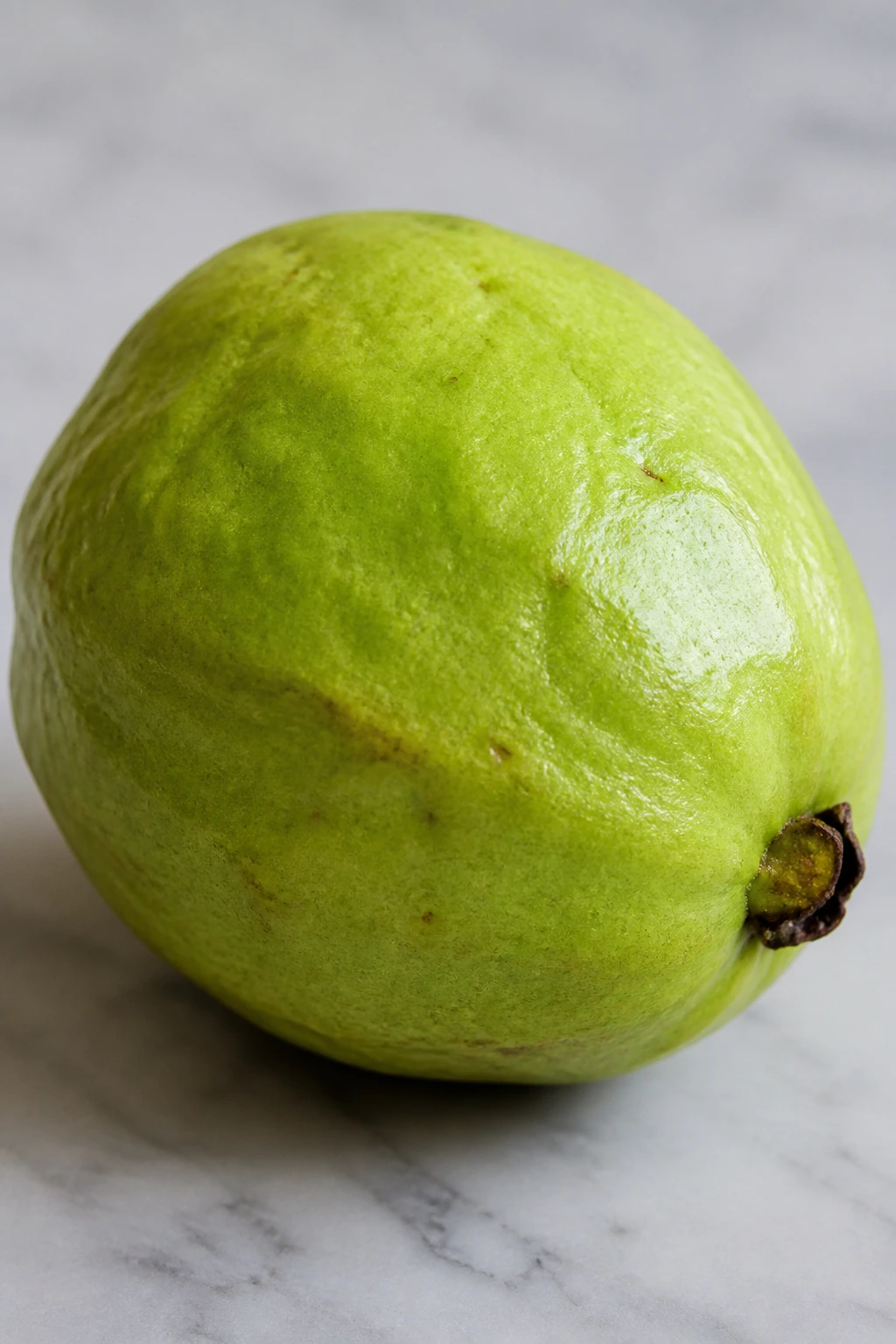 Is Guava Fruit Good For Diabetes? Benefits, Effects & More 14 Close-up of a ripe guava on a neutral surface