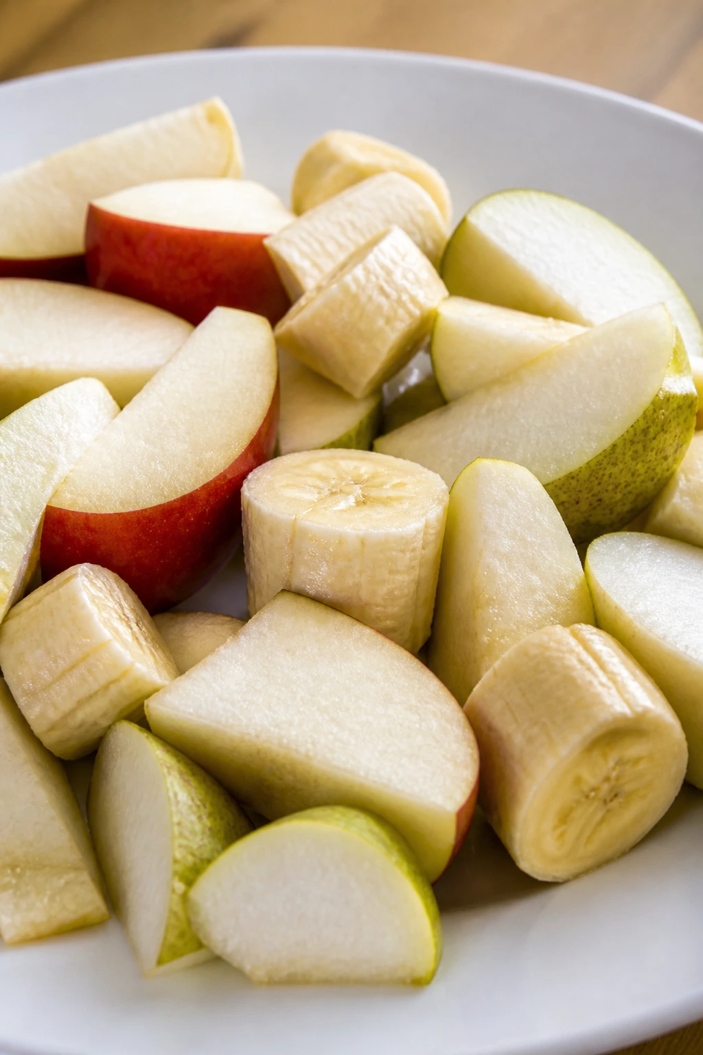 Can Gerbils Eat Watermelon? Let's Find Out 11 Plate with small apple, pear, and banana pieces for gerbils