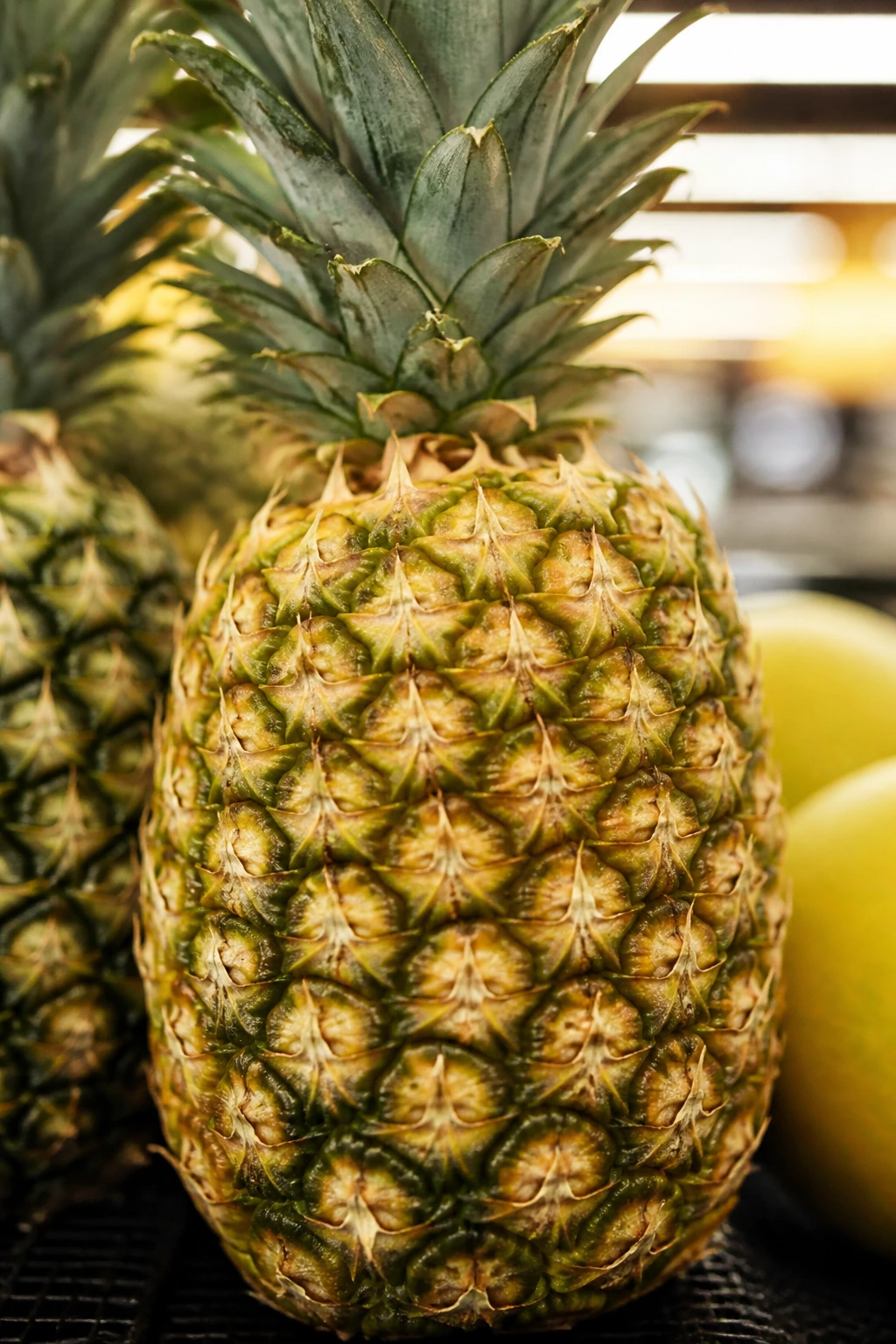 Understanding What Stickers on Fruits and Vegetables Mean 7 Close-up of a pineapple with no sticker on its skin in a grocery display
