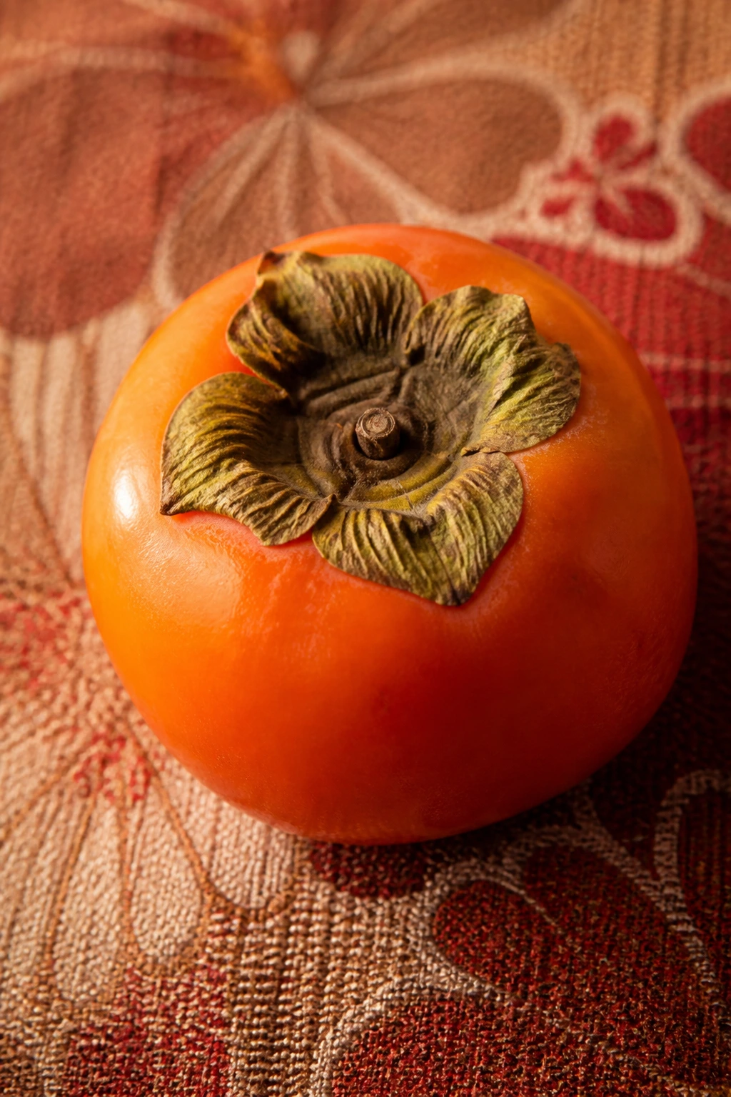 Persimmon against traditional Japanese textile background