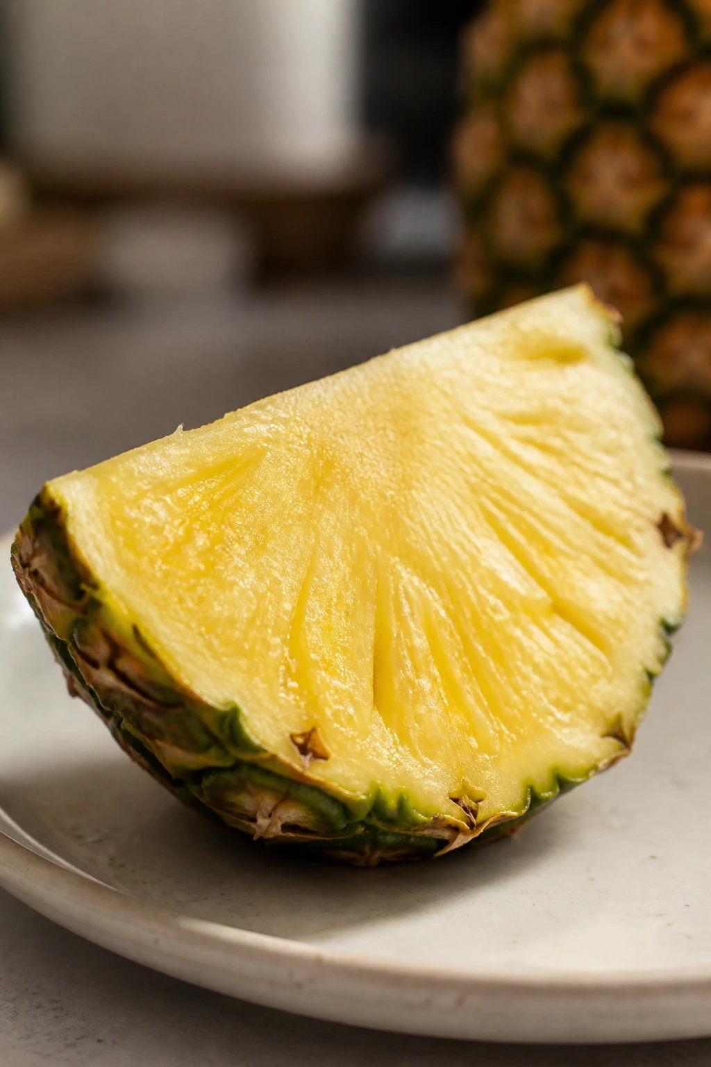 Is Pineapple Good For Gastritis? All You Need To Know 5 Close-up of a pineapple piece on a plate in a kitchen