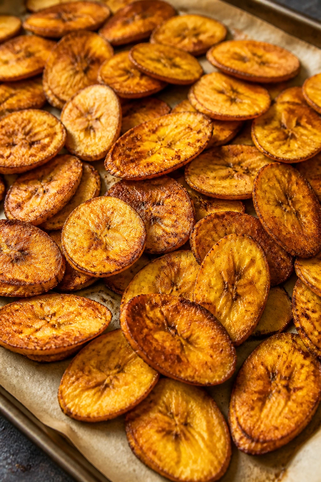 Is Plantain Good For Weight Loss? Yes, And Here's Why 5 Crispy baked plantain chips on parchment