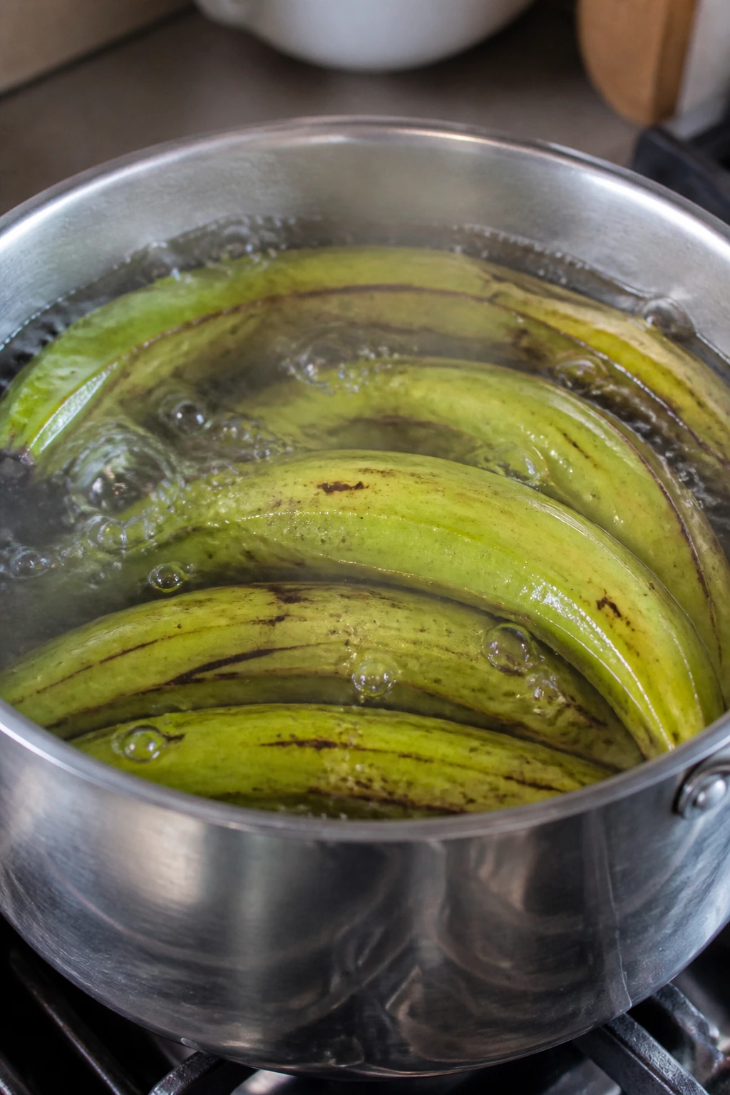 How Long To Boil Plantains? How To Boil Plantain Like A Pro 3 Green plantains boiling in a pot with steam