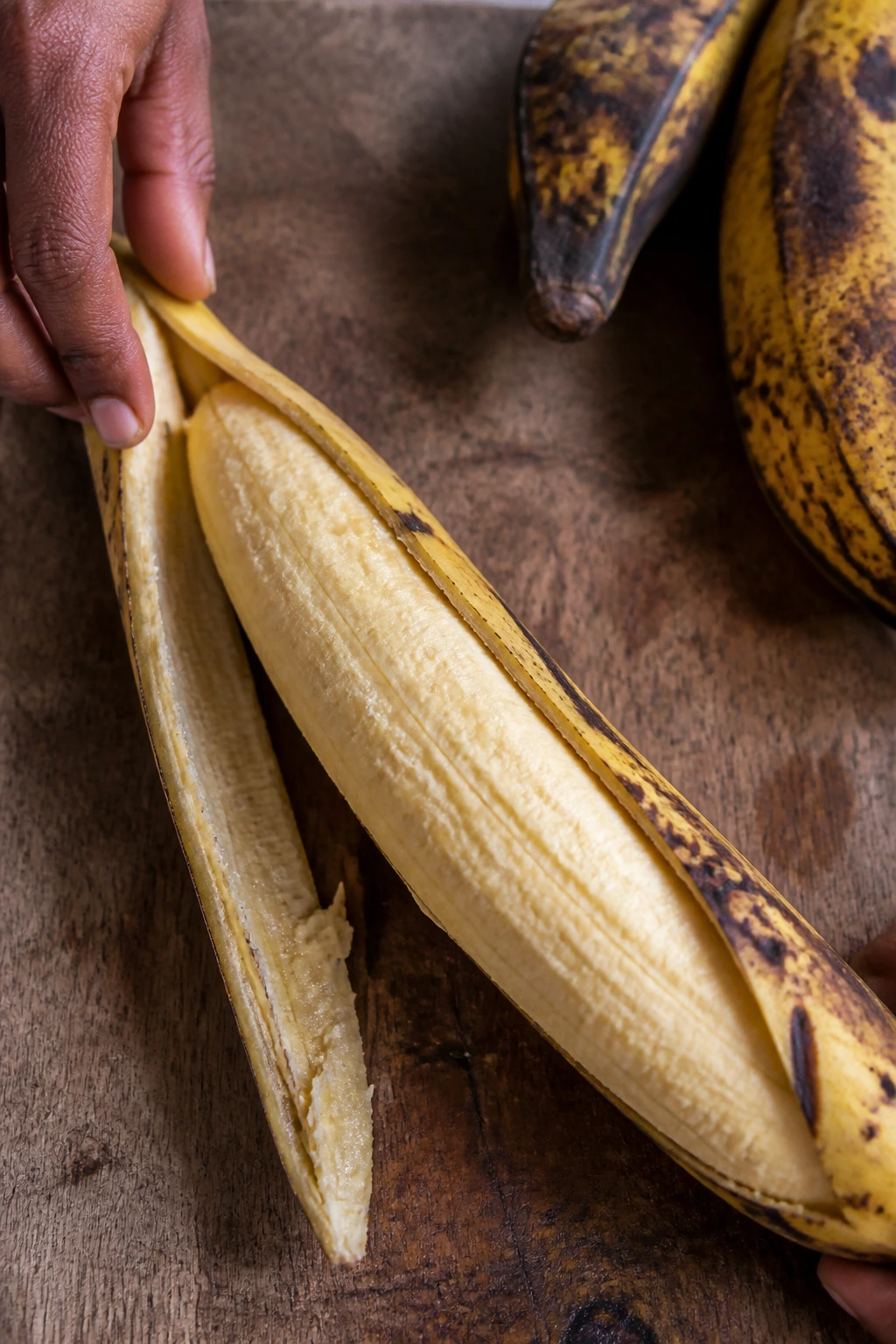 Is Plantain Good For Weight Loss? Yes, And Here's Why 4 Peeling ripe plantain on a cutting board