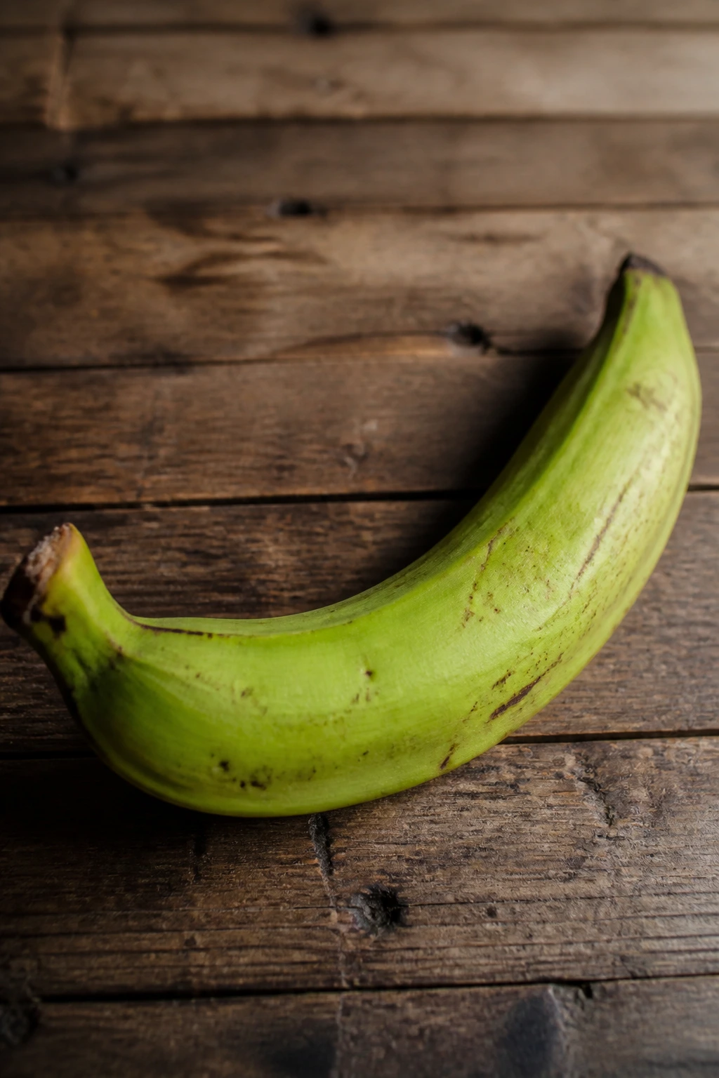 Are Plantains Gluten-Free? All You Need to Know 2 Close-up of a plantain on a rustic surface highlighting gluten-free fruit