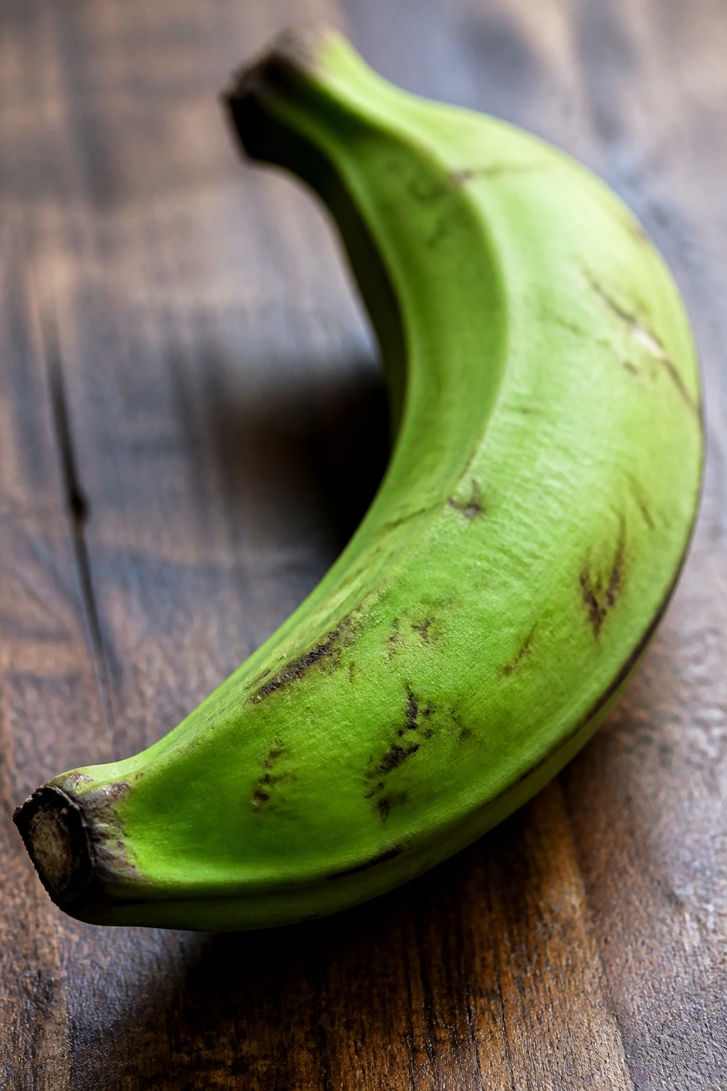 Are Plantains Keto-Friendly? All You Need To Know 2 Close-up of a single green plantain in a kitchen setting