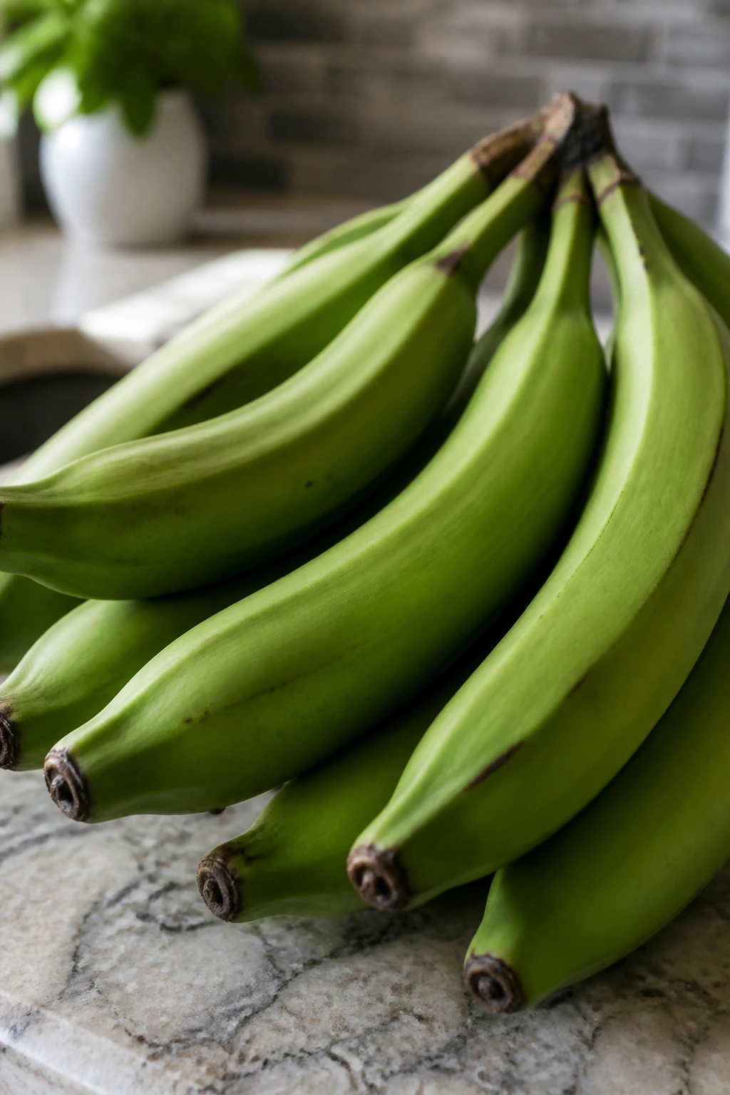 Close-up of fresh green plantains on a kitchen counter