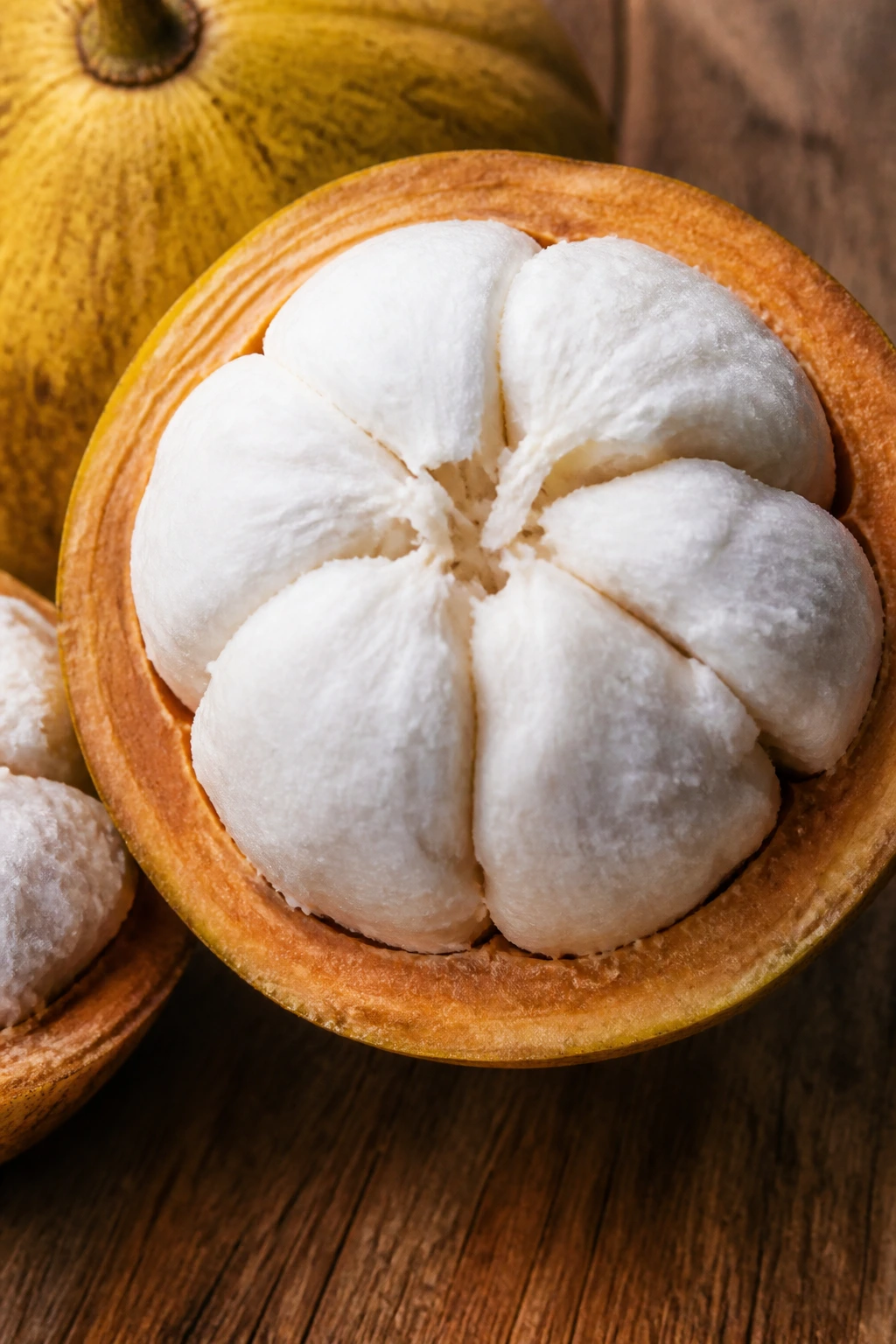How to Grow Santol from Seeds (Complete Guide) 11 Halved santol fruit showing pale flesh on wooden surface