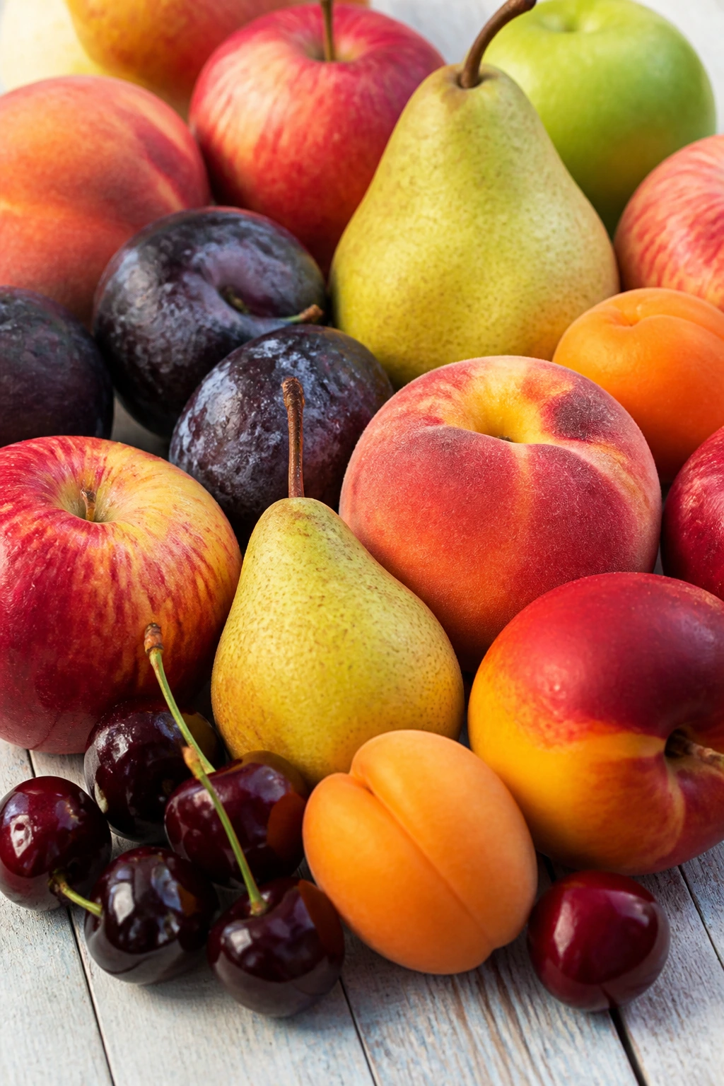 What Are Sub-Acid Fruits? Here's All You Need To Know 2 Colorful display of common sub-acid fruits arranged on a counter