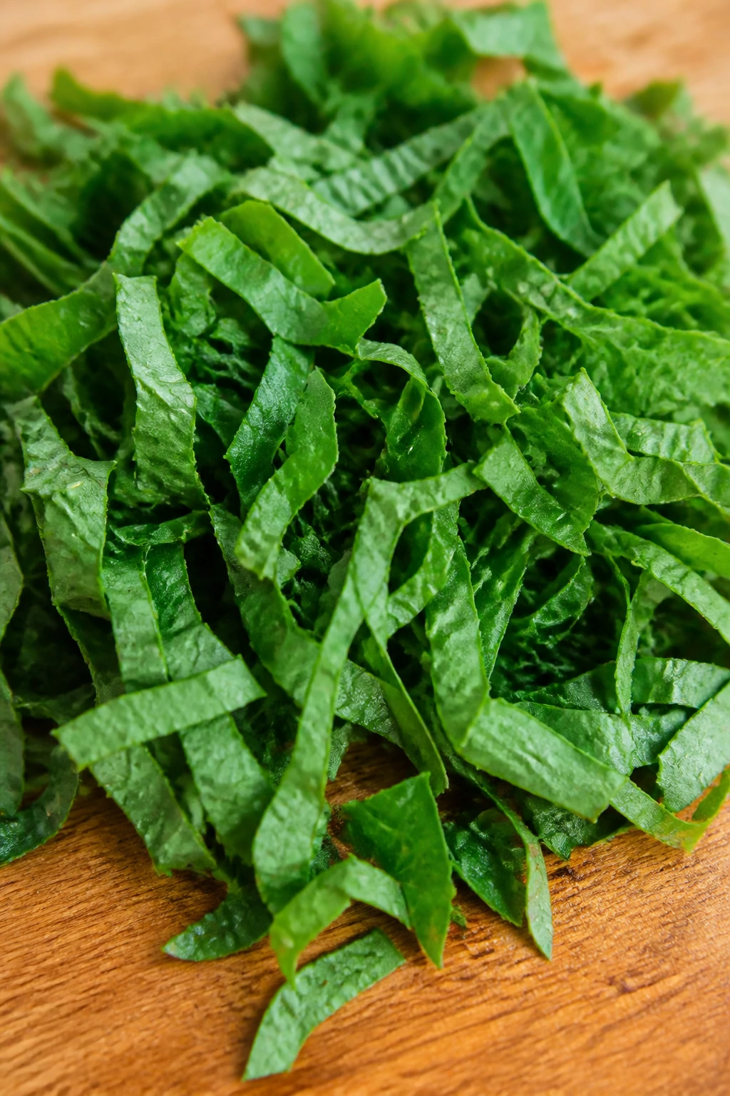 Are Watermelon Leaves Edible and Safe to Eat? 5 Chopped watermelon leaves on wooden cutting board ready to cook