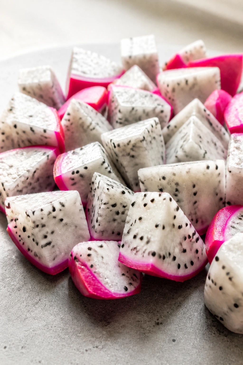 Dragon fruit snack pieces on a neutral background